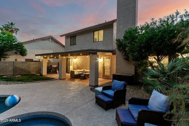 15621 S 37th Way, Phoenix, AZ 85048 - back of property featuring a patio area, a chimney, fence, an outdoor hangout area, and stucco siding