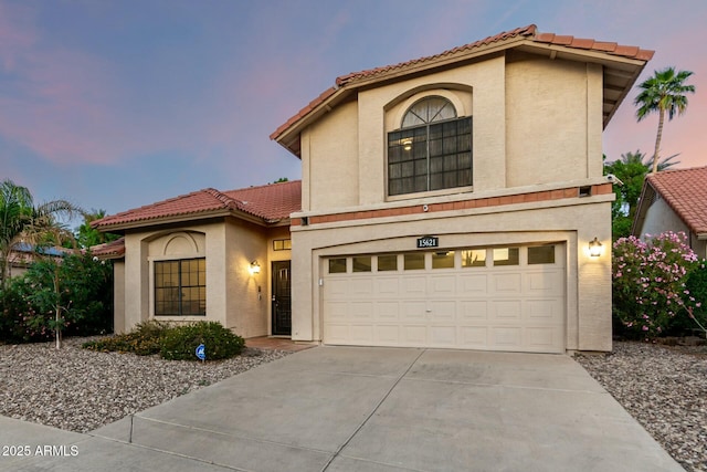 15621 S 37th Way, Phoenix, AZ 85048 - mediterranean / spanish home featuring an attached garage, a tile roof, driveway, and stucco siding