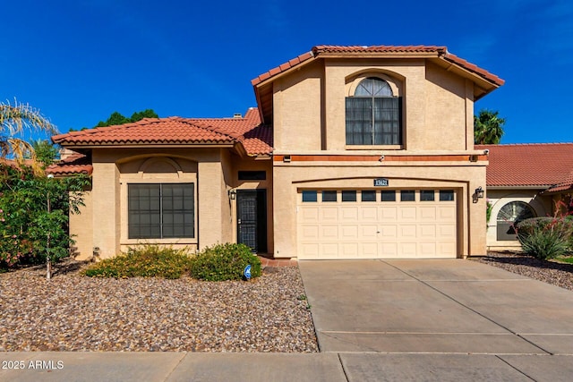 15621 S 37th Way, Phoenix, AZ 85048 - mediterranean / spanish home featuring stucco siding, an attached garage, concrete driveway, and a tiled roof