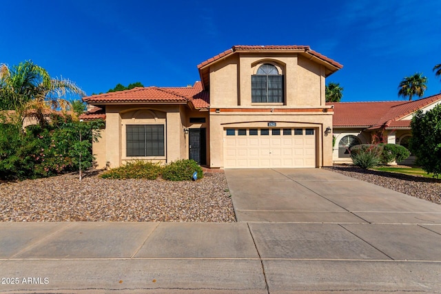 15621 S 37th Way, Phoenix, AZ 85048 - mediterranean / spanish house featuring an attached garage, concrete driveway, a tiled roof, and stucco siding