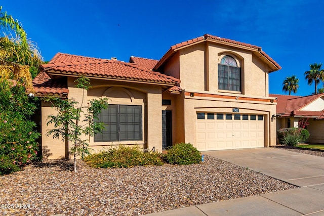 15621 S 37th Way, Phoenix, AZ 85048 - mediterranean / spanish-style home with concrete driveway, a tile roof, a garage, and stucco siding
