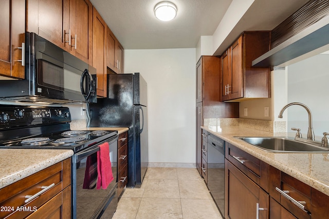 kitchen featuring sink, black appliances, light tile patterned flooring, and light stone counters