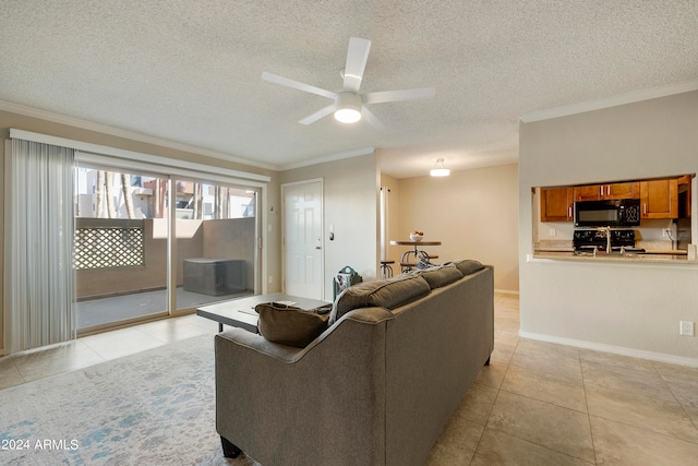 living room with ceiling fan, ornamental molding, a textured ceiling, and light tile patterned floors