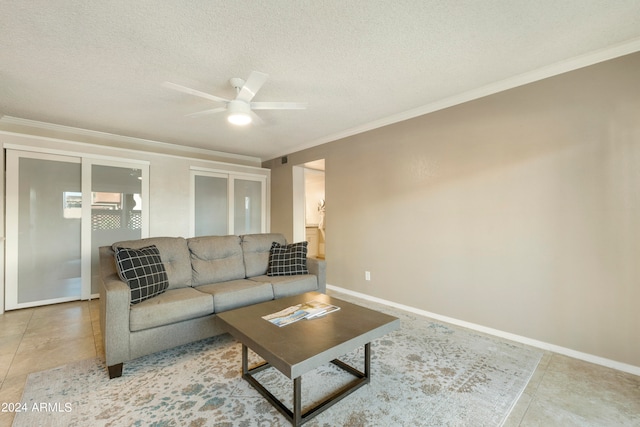 living room featuring crown molding, a textured ceiling, tile patterned floors, and ceiling fan