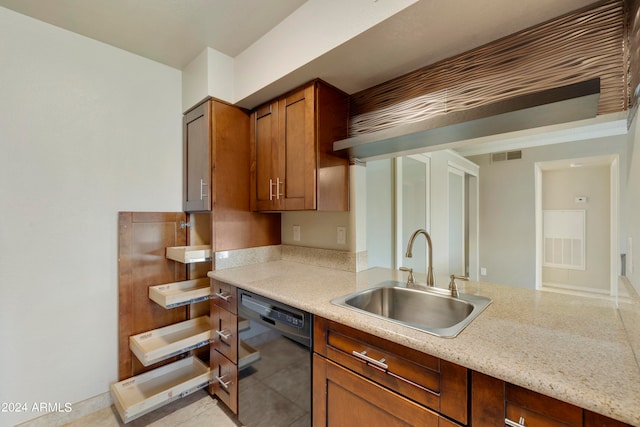 kitchen featuring black dishwasher, sink, and light stone counters