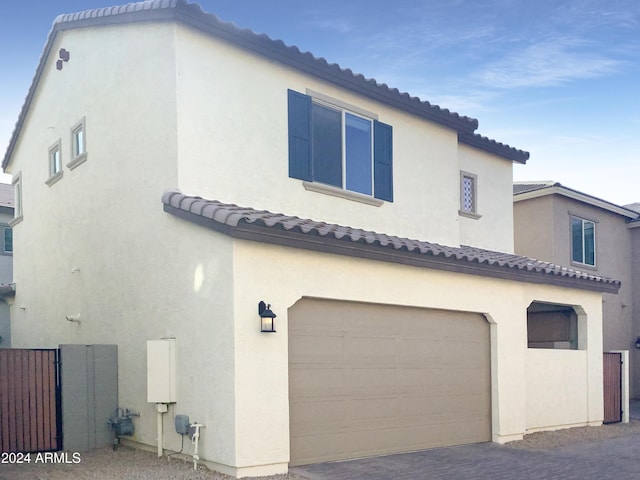 2550 N 149th Ave, Goodyear, AZ 85395 - back of property with an attached garage, a tile roof, stucco siding, and driveway