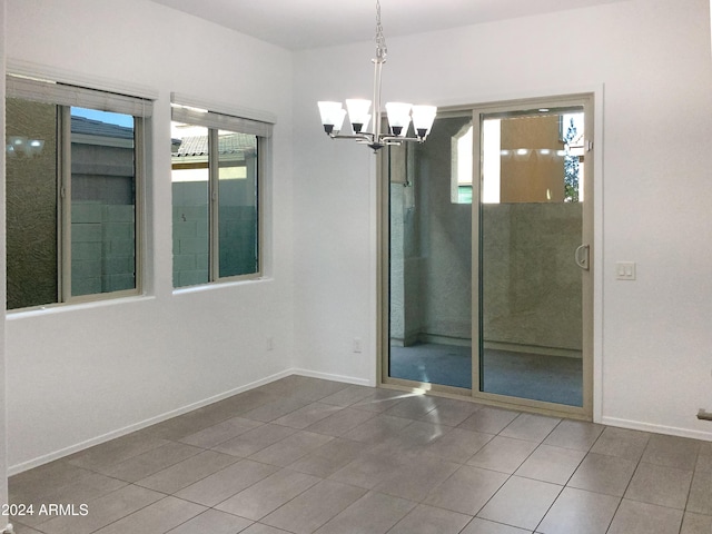 2550 N 149th Ave, Goodyear, AZ 85395 - tiled empty room featuring a chandelier, plenty of natural light, and baseboards