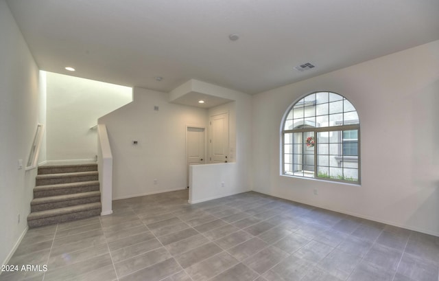 2550 N 149th Ave, Goodyear, AZ 85395 - unfurnished living room with stairs, baseboards, recessed lighting, and tile patterned flooring