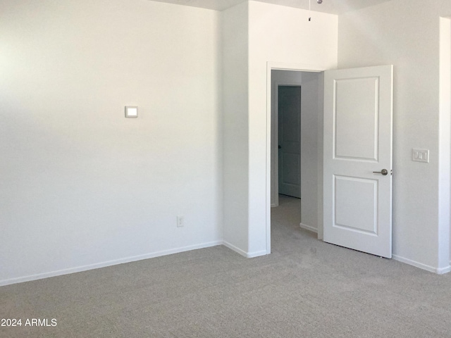 unfurnished room with light colored carpet