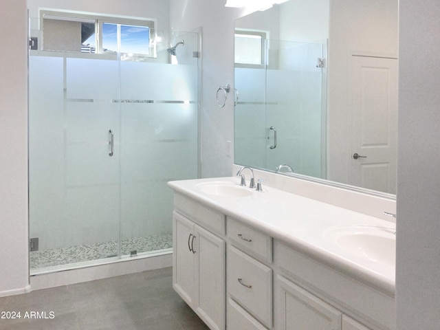 bathroom with vanity and a shower with shower door