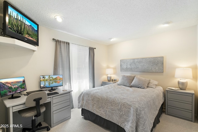 bedroom featuring carpet flooring and a textured ceiling