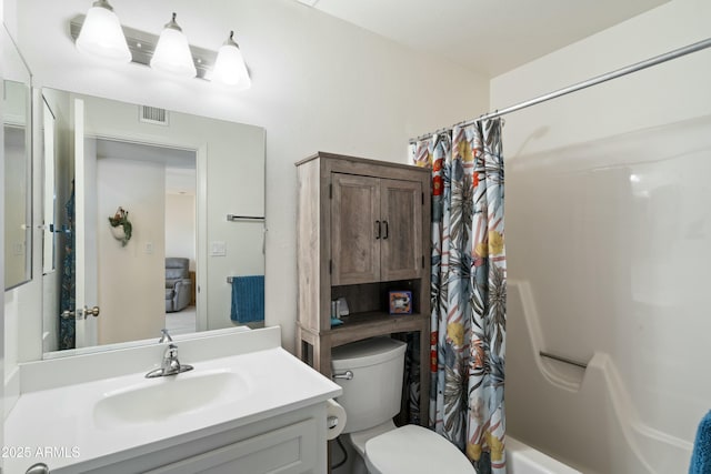 bathroom featuring shower / bath combo, visible vents, vanity, and toilet