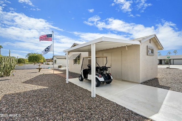 exterior space featuring fence and a carport