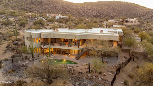 37433 N Never Mind Trl, Carefree, AZ 85377 - rear view of property featuring a balcony, stairway, stucco siding, a patio area, and a mountain view