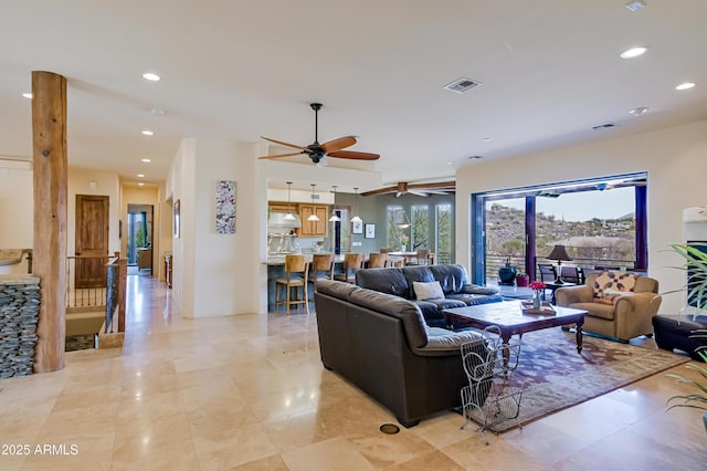 living area with a ceiling fan, recessed lighting, and visible vents