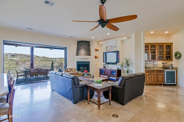 living room featuring visible vents, beverage cooler, recessed lighting, wet bar, and a ceiling fan