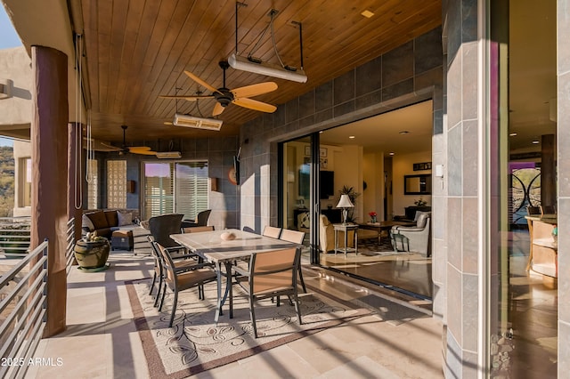 view of patio with outdoor dining space and a ceiling fan