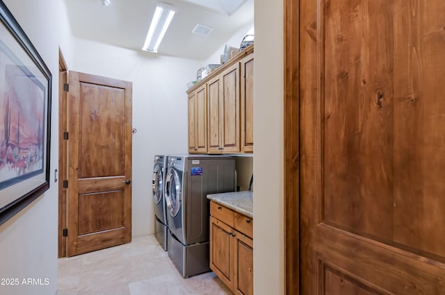 laundry area with visible vents, cabinet space, and washer and clothes dryer