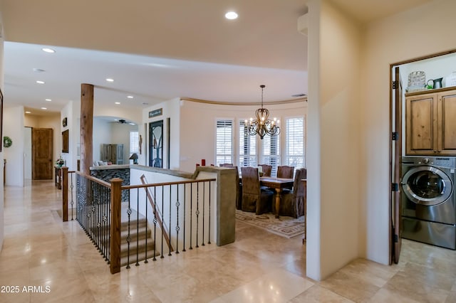 foyer with recessed lighting, washer / dryer, and an inviting chandelier