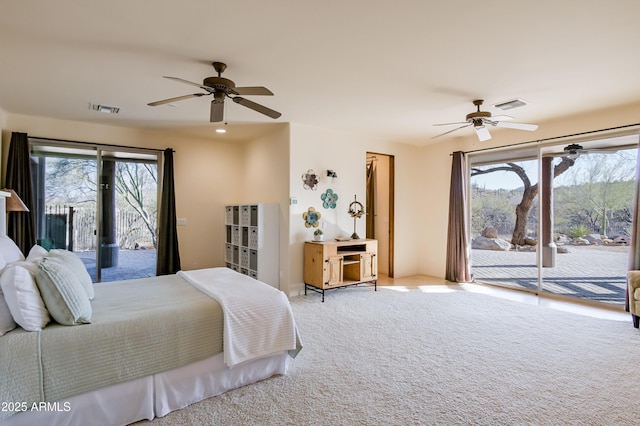 bedroom featuring access to outside, multiple windows, and visible vents