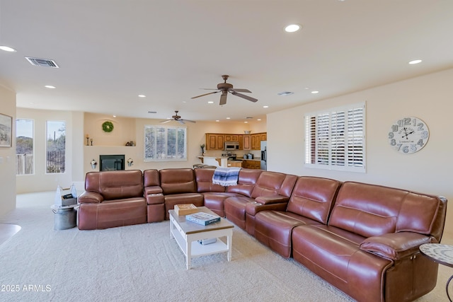 living room featuring visible vents, recessed lighting, light colored carpet, and a ceiling fan