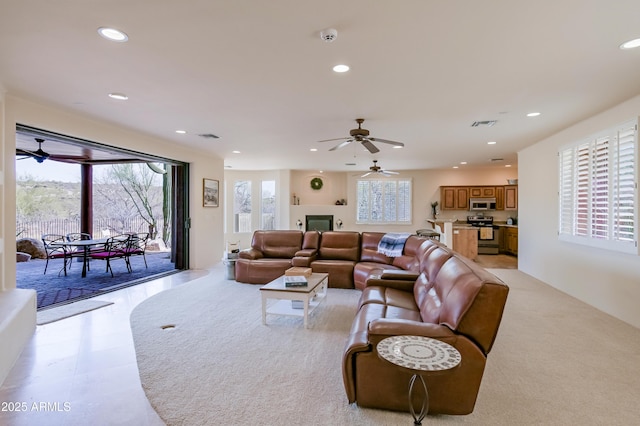 living room featuring recessed lighting, visible vents, plenty of natural light, and ceiling fan