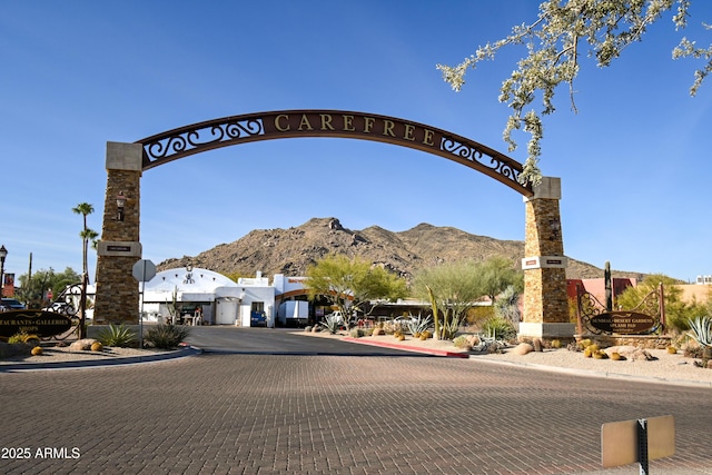 community sign with a mountain view