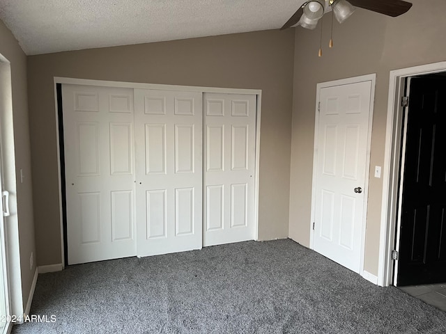 unfurnished bedroom featuring a textured ceiling, ceiling fan, carpet floors, and vaulted ceiling