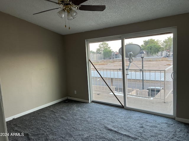 spare room with ceiling fan, carpet, and a textured ceiling