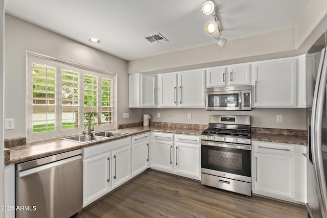 2438 W Via Dona Rd, Phoenix, AZ 85085 - kitchen with stainless steel appliances, a sink, white cabinetry, and recessed lighting