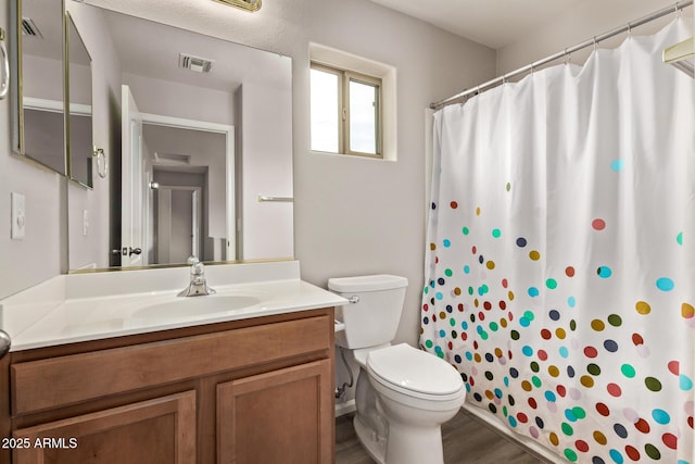 2438 W Via Dona Rd, Phoenix, AZ 85085 - bathroom featuring toilet, vanity, wood finished floors, and curtained shower