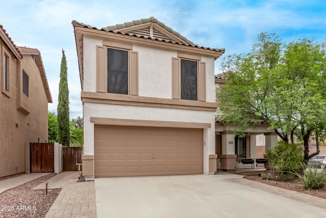 2438 W Via Dona Rd, Phoenix, AZ 85085 - view of front of property featuring an attached garage, stucco siding, a tiled roof, and driveway
