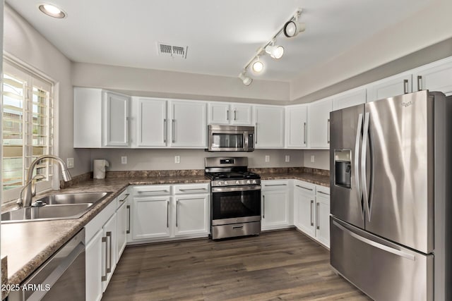 2438 W Via Dona Rd, Phoenix, AZ 85085 - kitchen with appliances with stainless steel finishes, a sink, white cabinetry, dark countertops, and recessed lighting