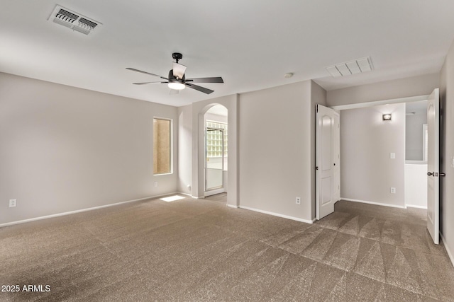 2438 W Via Dona Rd, Phoenix, AZ 85085 - empty room with arched walkways, a ceiling fan, carpet, and baseboards
