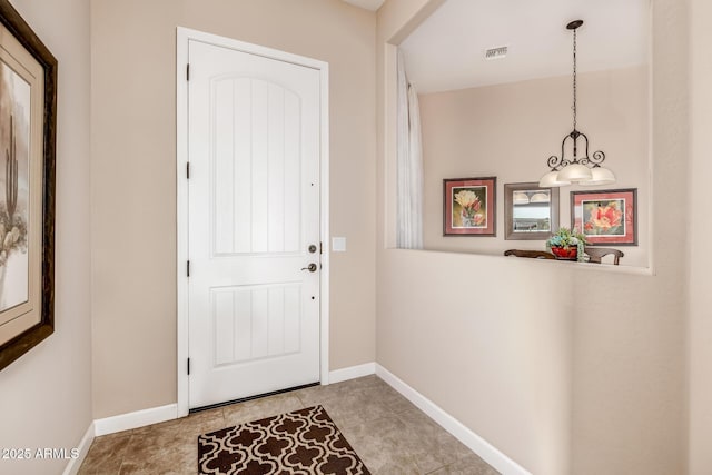 doorway featuring visible vents and baseboards