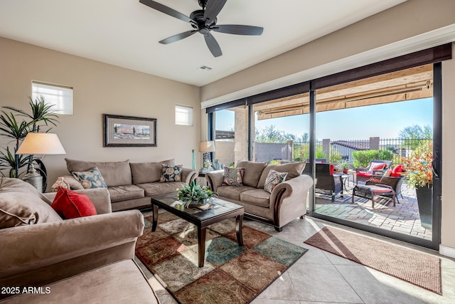 tiled living room featuring visible vents and ceiling fan