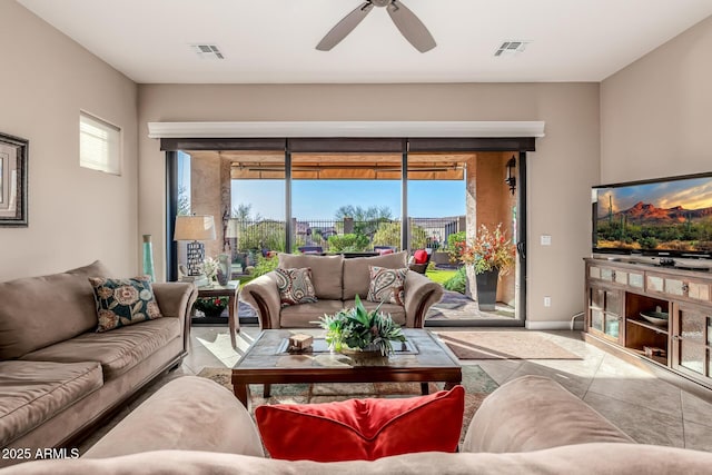 tiled living room with a healthy amount of sunlight, visible vents, and ceiling fan