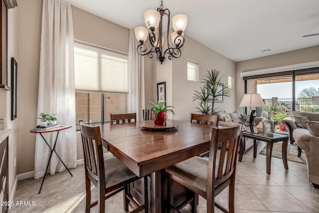 dining space featuring light tile patterned floors, visible vents, and a chandelier