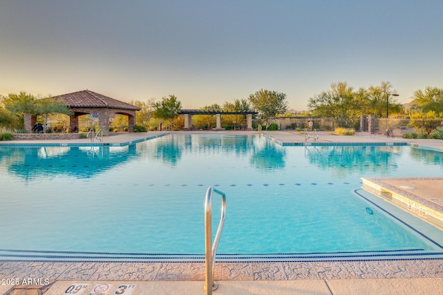 pool featuring a gazebo, a patio area, and fence