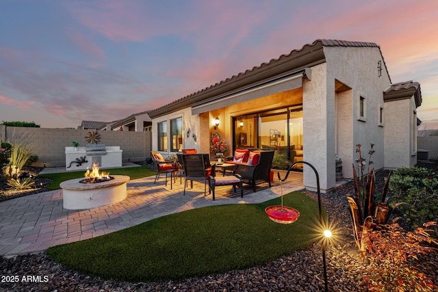 view of patio / terrace with cooling unit, an outdoor living space with a fire pit, and fence