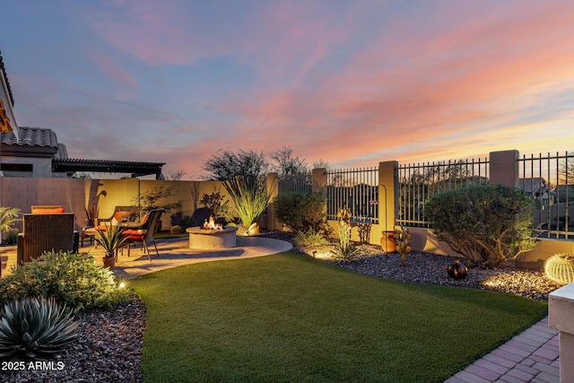 view of yard featuring a patio area, an outdoor fire pit, and fence private yard