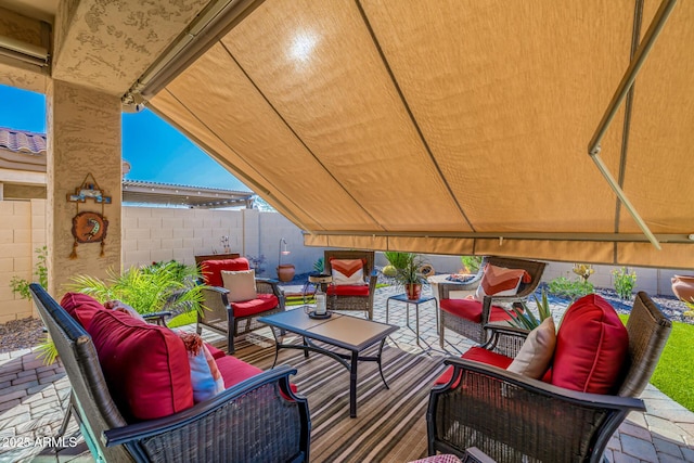 view of patio / terrace featuring outdoor lounge area and fence