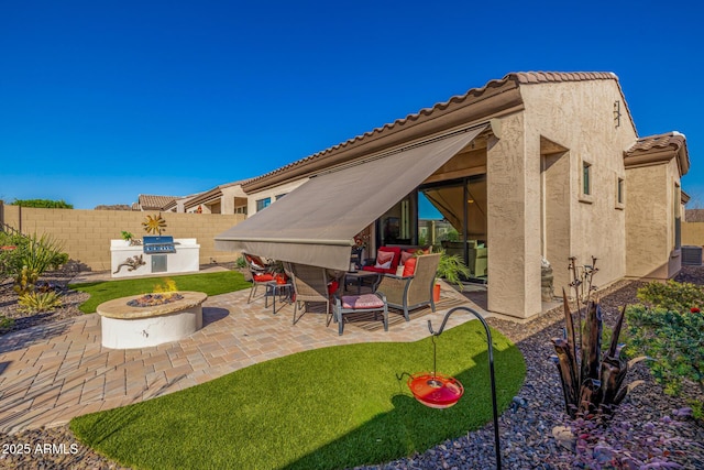 view of patio / terrace featuring central AC unit, a fire pit, and fence