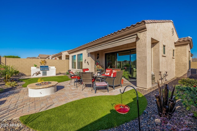 view of patio / terrace with a fire pit and fence