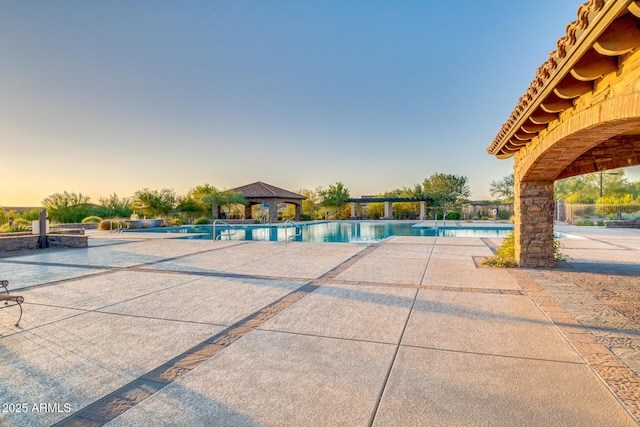 community pool featuring a gazebo and a patio area