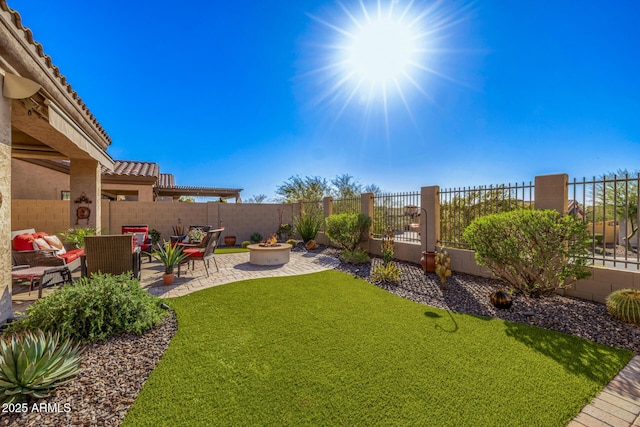 view of yard featuring a patio area, an outdoor fire pit, and a fenced backyard