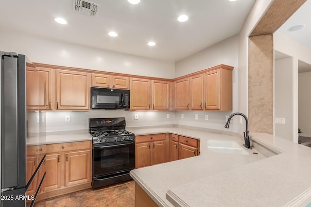 2342 W Owens Ct, Anthem, AZ 85086 - kitchen featuring black appliances, a sink, a peninsula, light countertops, and recessed lighting