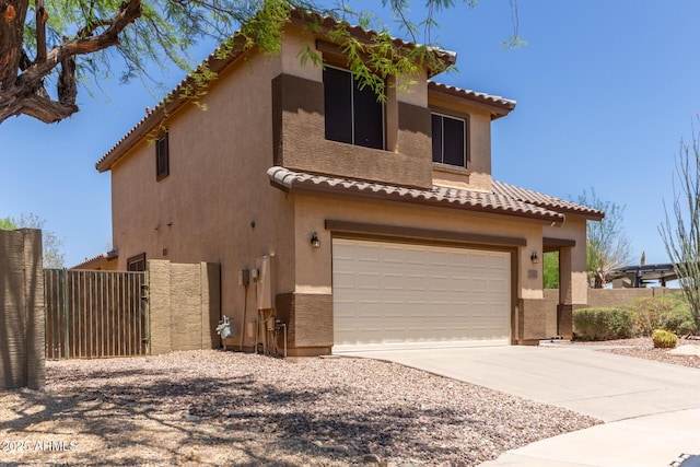 2342 W Owens Ct, Anthem, AZ 85086 - mediterranean / spanish-style home with an attached garage, a tiled roof, stucco siding, and concrete driveway