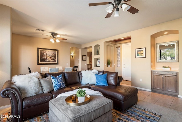 tiled living room with ceiling fan