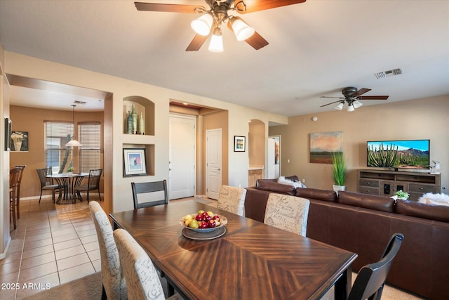 tiled dining room with ceiling fan